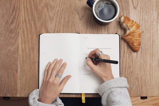 Woman writing tasks in to do list