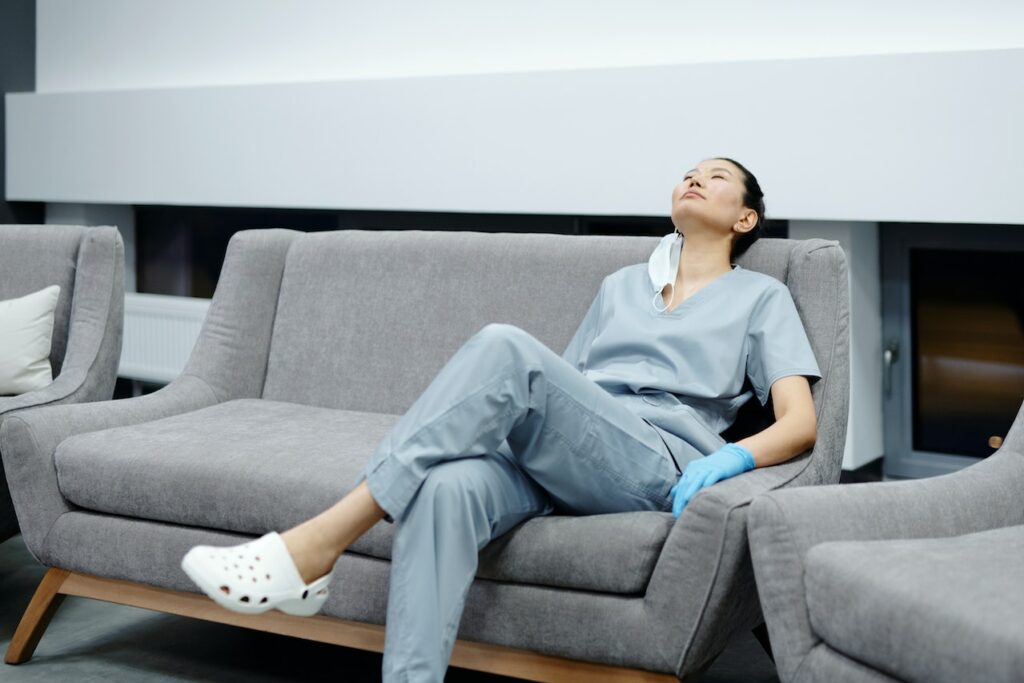 Exhausted nurse sitting on couch