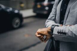 Well dressed man looking at wrist watch