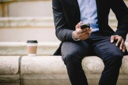Man sitting on outdoor steps looking at phone