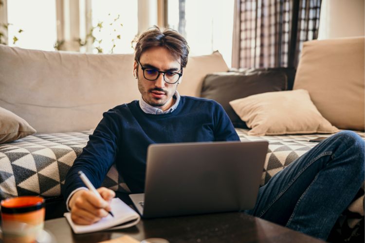 Man working on a laptop on a couch