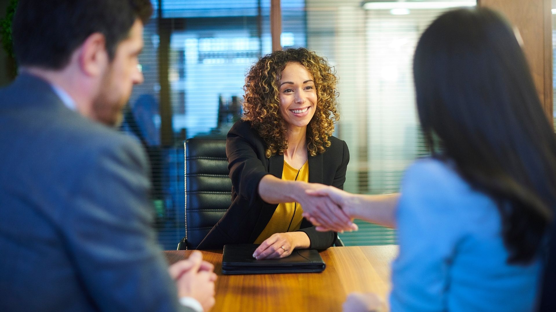 person shaking hands with hiring team