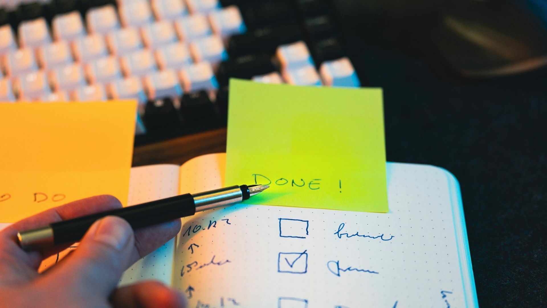 person ticking off done items on a list